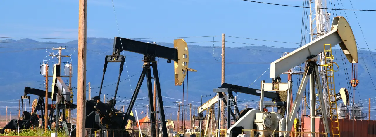 Oilfield with pumpjacks and infrastructure highlighting the importance of choosing the right cementing additives
