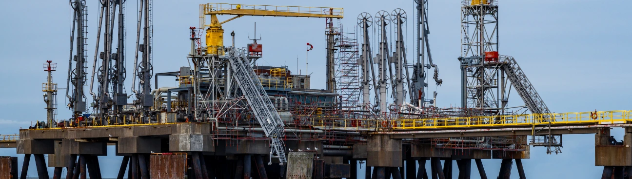 Offshore oil rig platform with machinery and pipelines, illustrating upstream oil extraction operations and industry trends for 2025