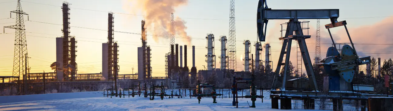 Oil refinery with pumpjack at sunset, showing where clay stabilizers improve drilling and wellbore stability.